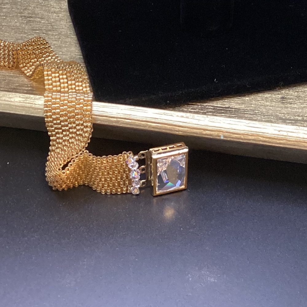 Hand beaded peyote style gold luster bracelet. Swarovski emerald cut crystal